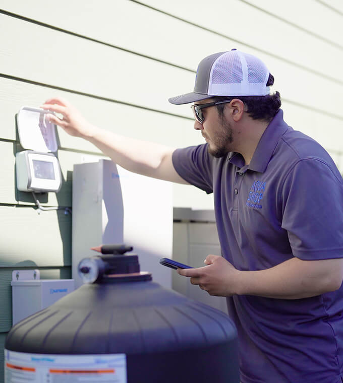 Technician troubleshooting pool equipment during an on-demand repair