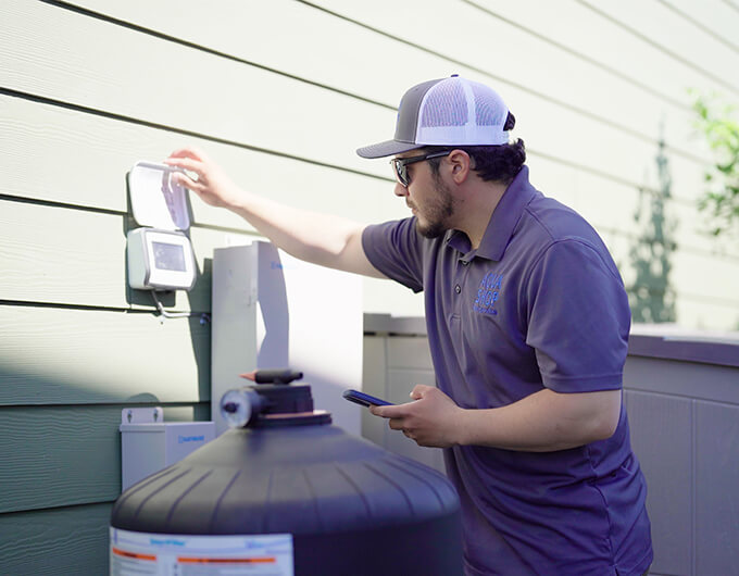 Homeowner with Aqua Shop technician reviewing pool equipment service